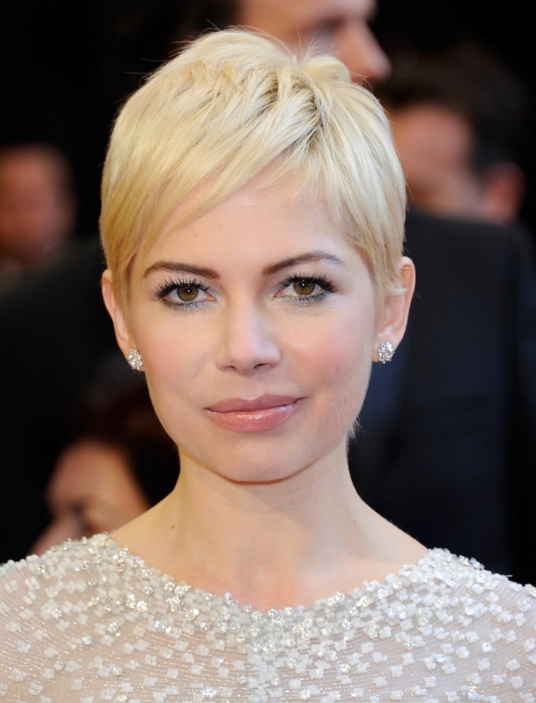 Michelle Williams, in her signature pixie hairdo, arrives at the Academy Awards on February 27, 2011 in Hollywood, California.