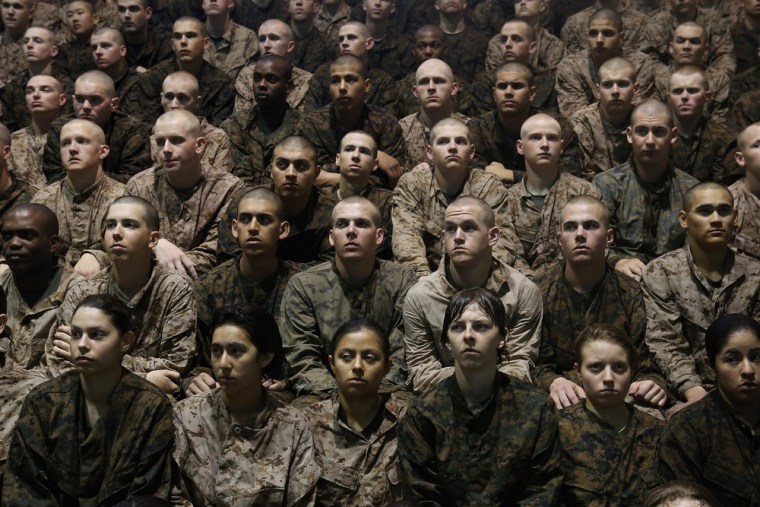 Female and male Marine recruits listen to instructions as they prepare for a swimming test during boot camp.
