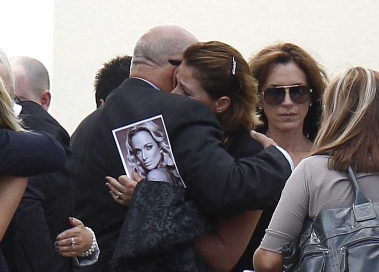 Barry Steenkamp, father of Reeva Steenkamp, is embraced after her memorial service at the Victoria Park Crematorium in Port Elizabeth, South Africa on Feb. 19.