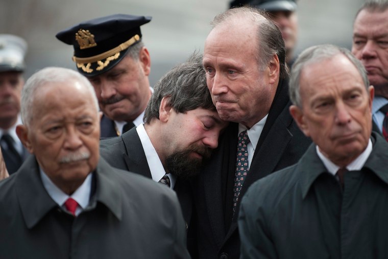 Stephen Knapp, center left, is comforted by Charles Maikish, former World Trade Center director, as mourners and family members of victims participate in a 20th anniversary memorial for victims of the 1993 bombing of the World Trade Center in New York on Feb. 26.