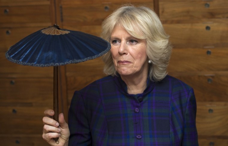 Britain's Camilla, Duchess of Cornwall, holds a mini parasol during a visit to the Fan Museum in Greenwich, south-east London on February 21, 2013. Th...