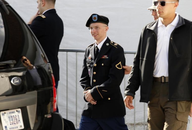 Army Pfc. Bradley Manning is escorted in handcuffs as he leaves the courthouse in Fort Meade, Maryland, on June 6.