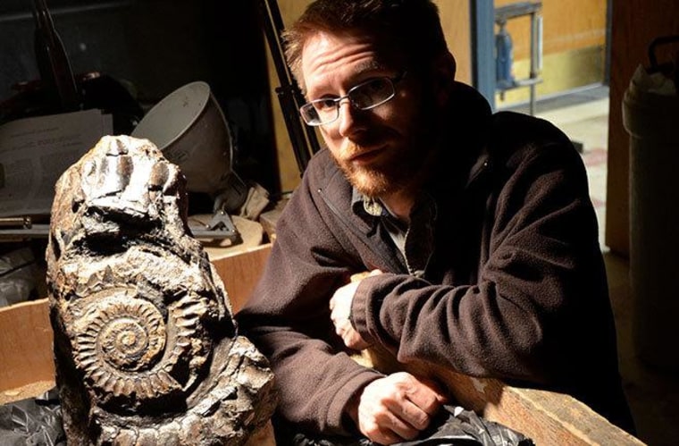 Leif Tapanila, an associate professor in the Department of Geosciences at Idaho State University, with the Helicoprion fossil.