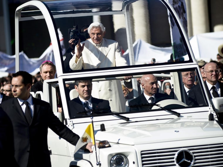 Pope Benedict XVI waves to the crowd from the specially modified Mercedes dubbed the \"Popemobile.\"