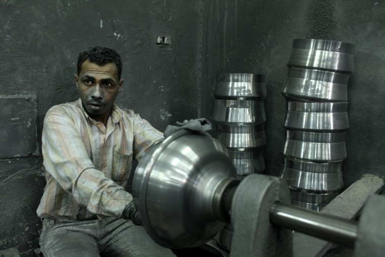 epa03589639 An Egyptian man works in an aluminium factory, downtown Cairo, Egypt, 18 February 2013. The Egyptian government is expecting an IMF delegation to visit Egypt again this month to resume talks on the 4.8 billion dollars loan, which the government hopes it could alleviate the ailing economy. The ruling Islamists have so far failed to revive the economy and the unrest has also debilitated the tourism industry, which was a key pillar of the economy under the rule of former president Hosni Mubarak. EPA/ABIR ABDULLAH