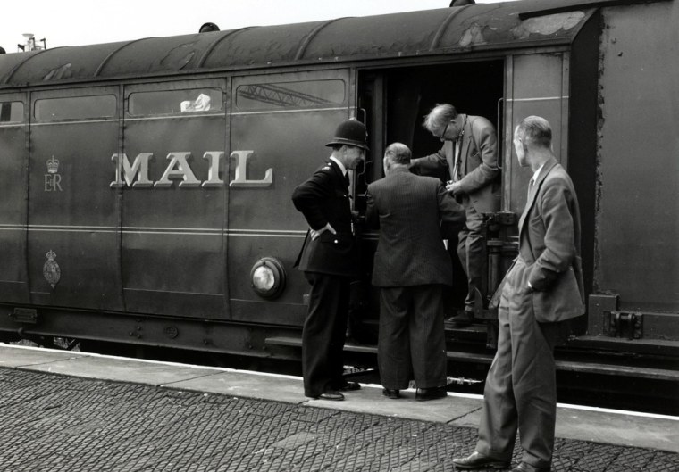 Detectives inspect the Royal Mail train from which over 2.6 million pounds was stolen, on Aug. 8, 1963, in Cheddington, Buckinghamshire, England.