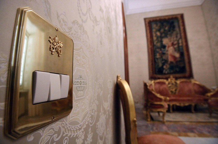 A light switch bears the Papal seal.