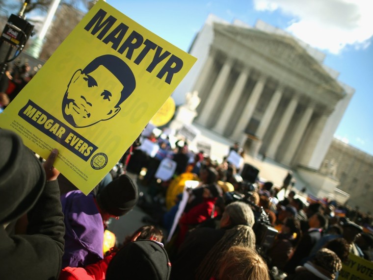With images of murdered Mississippi civil rights worker Medgar Evers, demonstrators rally in front of the U.S. Supreme Court February 27, 2013 in Washington, DC.