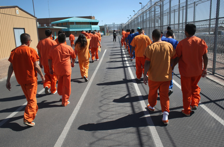 Immigrant detainees walk through the Immigration and Customs Enforcement (ICE), detention facility on Thursday.