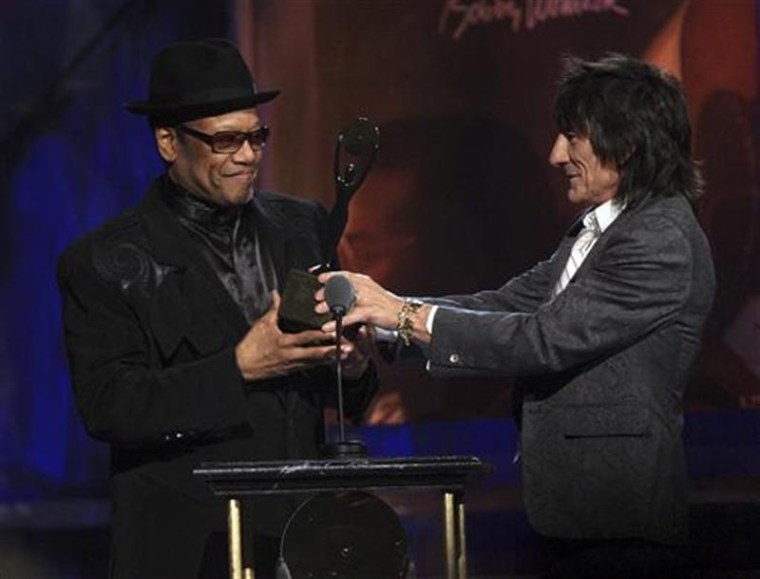 Bobby Womack accepts his induction trophy into the Rock and Roll Hall of Fame from Rolling Stones member Ronnie Wood in 2009.
