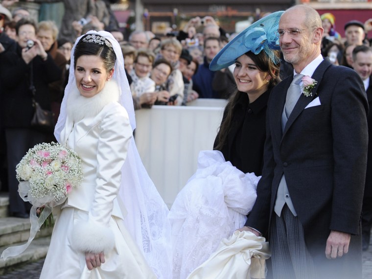 Adelaide Drape-Frisch smiles with her father Philippe Drape-Frisch and her sister Alienor Drape-Frisch in front of the Saint Epvre Basilica before her wedding.