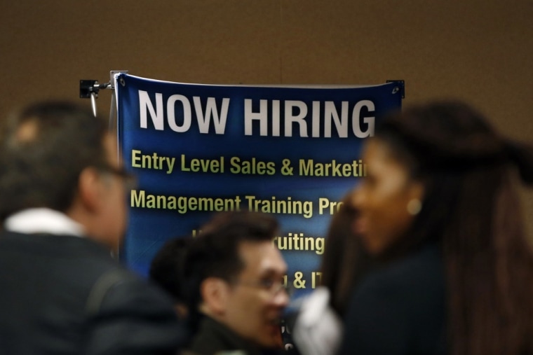 Job seekers stand in line to meet with prospective employers at a career fair in New York City in this file photo taken October 24, 2012.