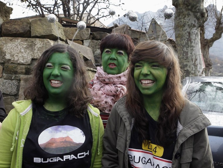 Residents dressed as extraterrestrials with green-painted faces walk the streets of Bugarach, France, which was touted as a safe haven from the end of the world on Dec. 21, 2012.