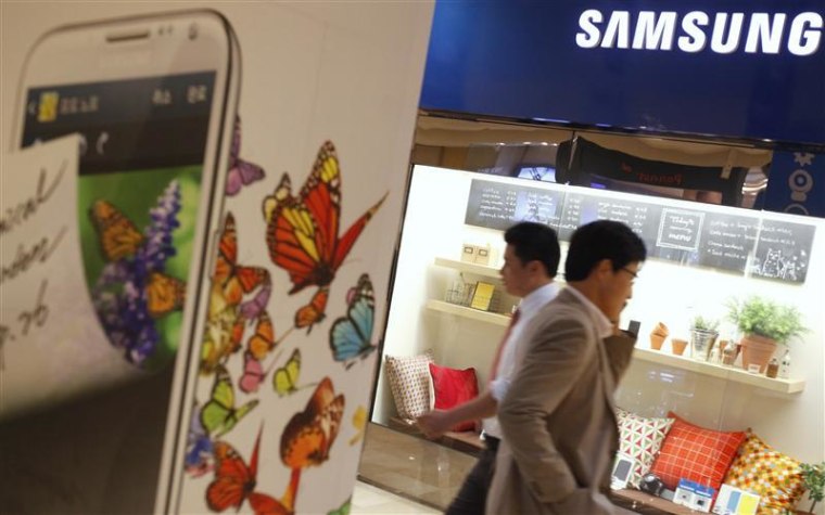People walk at a Samsung Electronics store in the Gangnam area in Seoul
