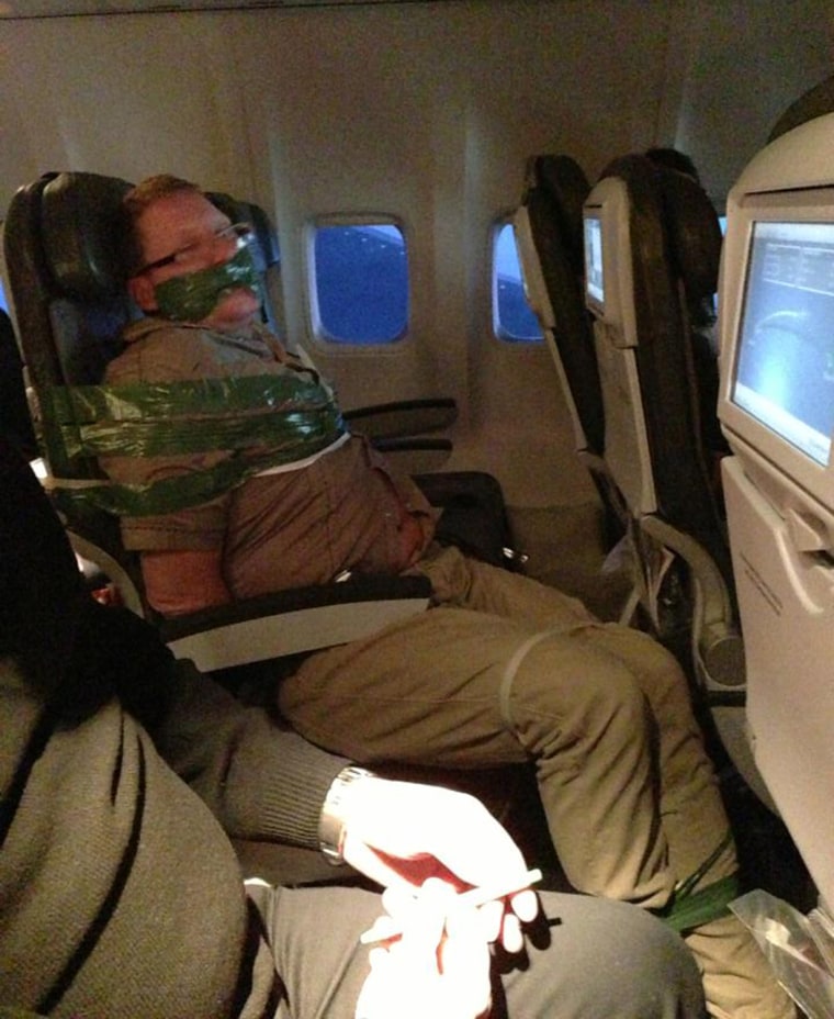 Image: Unruly passenger taped to seat