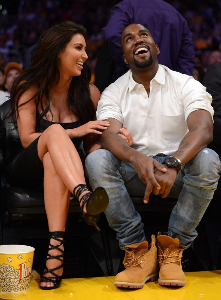 High-heeled: Kim and Kanye watch the video board from their courtside seats as the Los Angeles Lakers take on the Denver Nuggets in the 2012 NBA Playoffs on May 12 in Los Angeles.