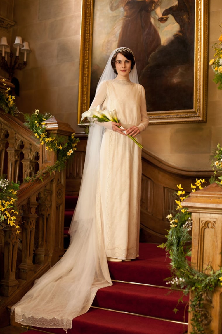 Lady Mary Crawley (played by British actress Michelle Dockery) poses in her pricey wedding gown.