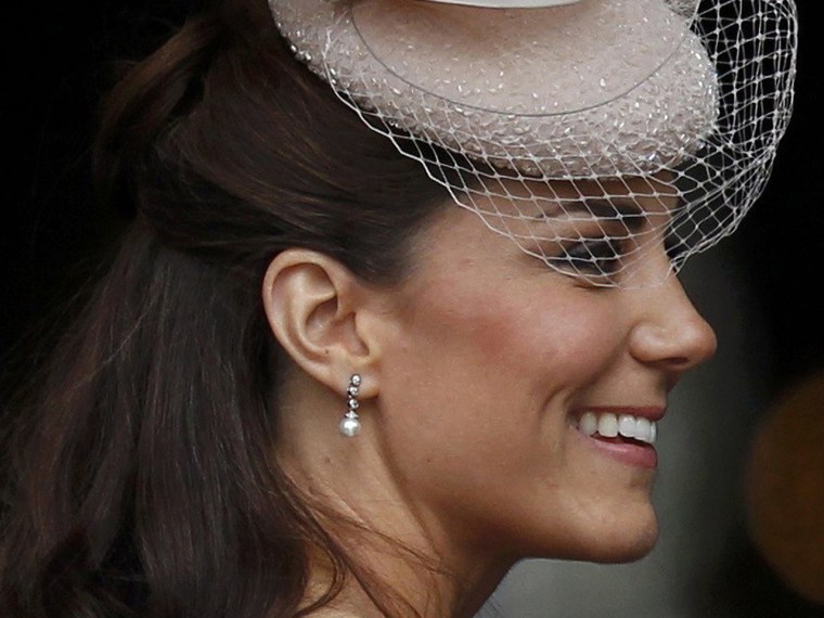 The Duchess shows off a pair of knockoff earrings during the Diamond Jubilee in London on June 5.