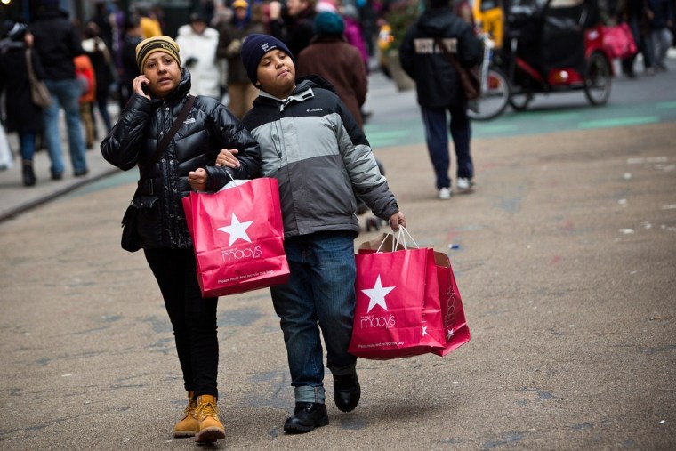 Shoppers walk through Herald Square after shopping at Macy's department store on December 26, 2012 in New York City.