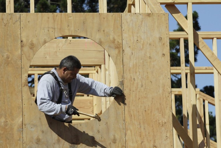 Home builder Mario Sanchez hammers a new home in Palo Alto, Calif., Monday, June 18, 2012.