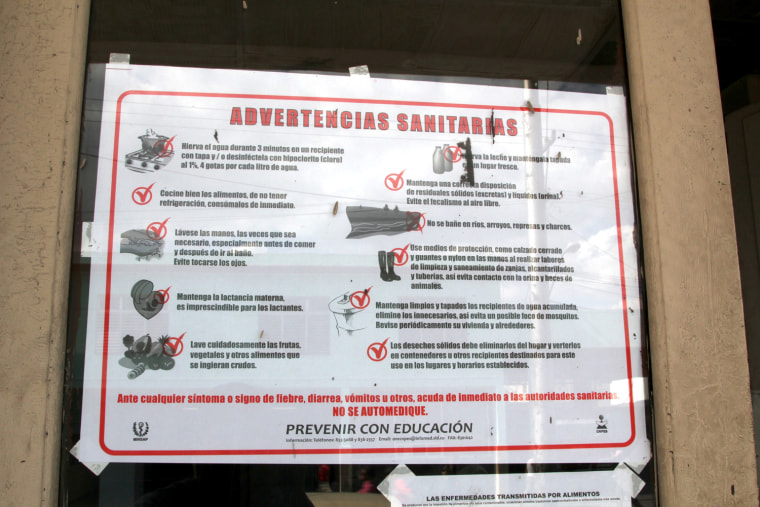 Signs such as this one are posted everywhere in Havana, alerting people to go to the hospital as soon as they experience any of the symptoms of cholera.