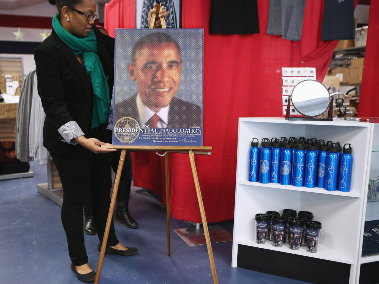 Store manager Liz Matory prepares merchandise, including this commemorative poster by artist Chuck Close, for the grand opening of the Presidential Inaugural Committee's store.