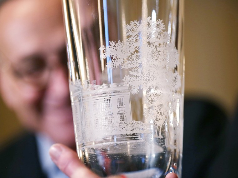 Sen. Chuck Schumer, chairman of the Joint Congressional Committee on Inaugural Ceremonies, inspects one of the two crystal vases that will be given to President Obama and Vice President Biden during the inaugural luncheon.