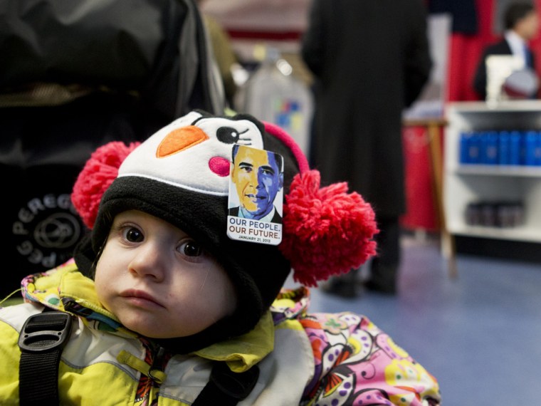 Phoebe Stevens, 1, wears a pin of President Barack Obama on her hat purchased by her nanny at the PIC store.