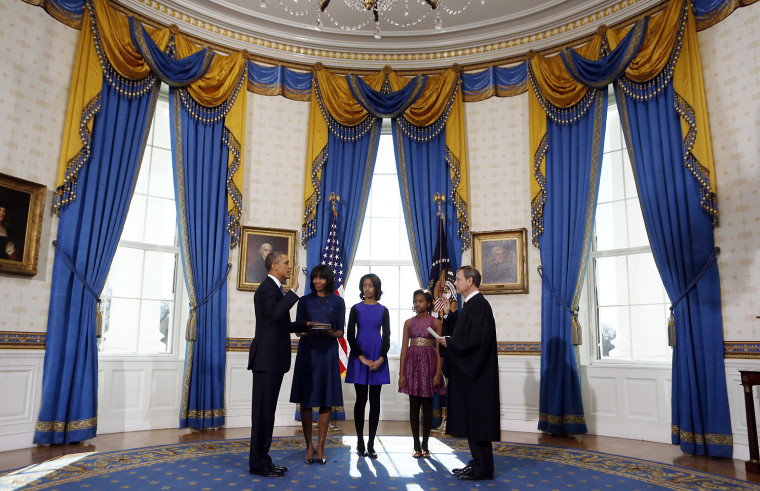 President Barack Obama, left, takes the oath of office from U.S. Supreme Court Chief Justice John Roberts, right, as first lady Michelle Obama holds the bible and daughters Malia and Sasha look on in the Blue Room of the White House, Jan. 20, in Washington, D.C. Obama and Vice President Joe Biden were officially sworn in a day before the ceremonial inaugural swearing-in.