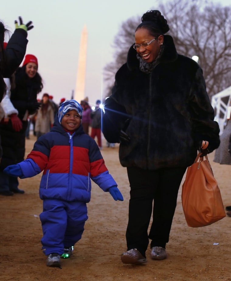 People smile as they enter the National Mall for the ceremonial swearing-in ceremonies on the West front of the U.S. Capitol.