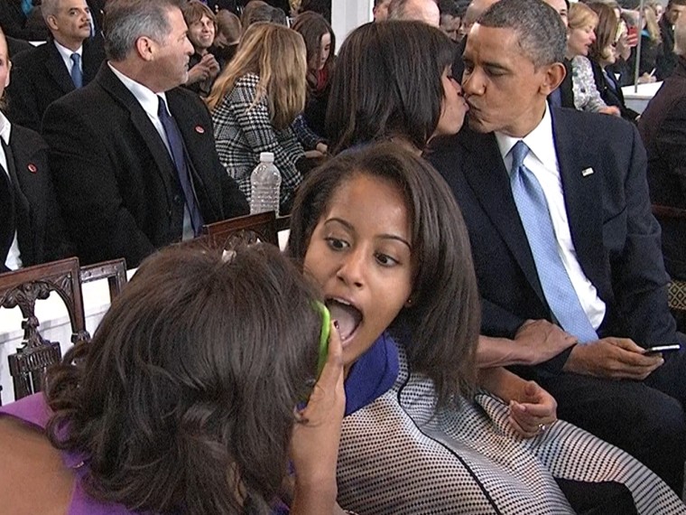 First daughters Malia and Sasha Obama seemed completely unfazed by their smoochy parents.