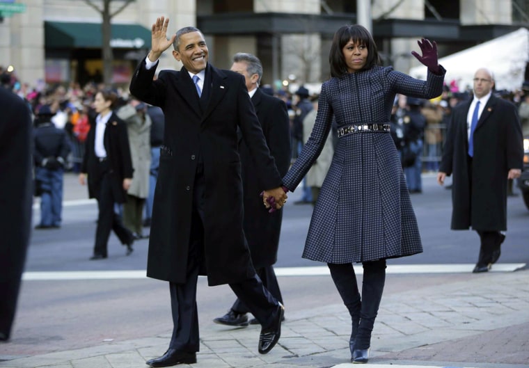 The Obamas held hands as they walked down Pennsylvania Avenue during the 57th presidential inauguration parade on Monday in Washington, D.C.