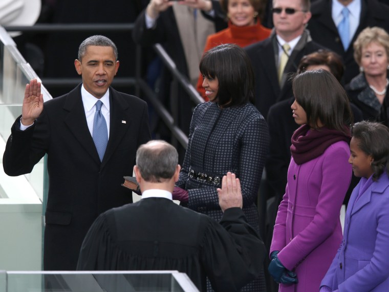 President Barack Obama is sworn in by Supreme Court Chief Justice John Roberts as First lady Michelle Obama and daughters, Sasha Obama and Malia Obama look on during the public ceremonial inauguration on the West Front of the U.S. Capitol on Jan. 21, 2013.