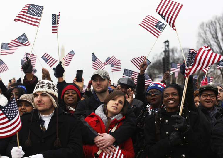 People cheer on the National Mall during the ceremonial swearing-in ceremonies on the West front of the U.S. Capitol in Washington, D.C., on Jan. 21.