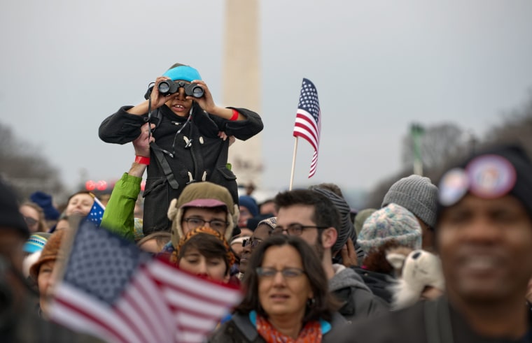 A group of people on the National Mall react as President Barack Obama is ceremonially sworn in for a second term as the 44th President of the United States in Washington, D.C., on Jan. 21.