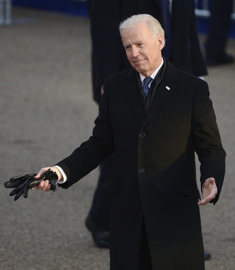 Biden breaks out a puzzling look for the crowd while walking along Pennsylvania Avenue in the inaugural parade.
