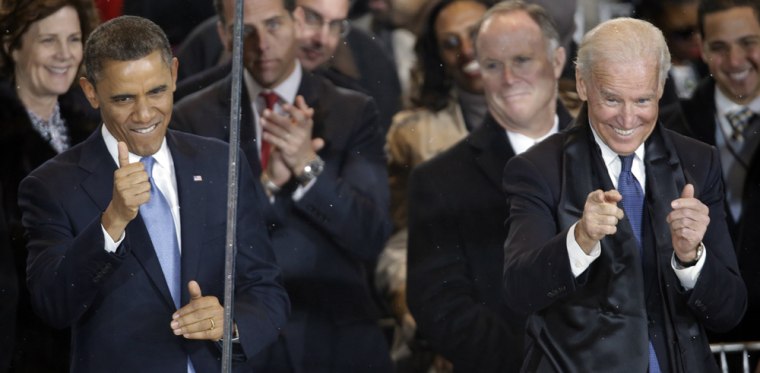 Vice President Joe Biden gives the thumbs up and the finger point as he and President Barack Obama react during the inaugural parade on Pennsylvania Avenue near the White House on Monday.