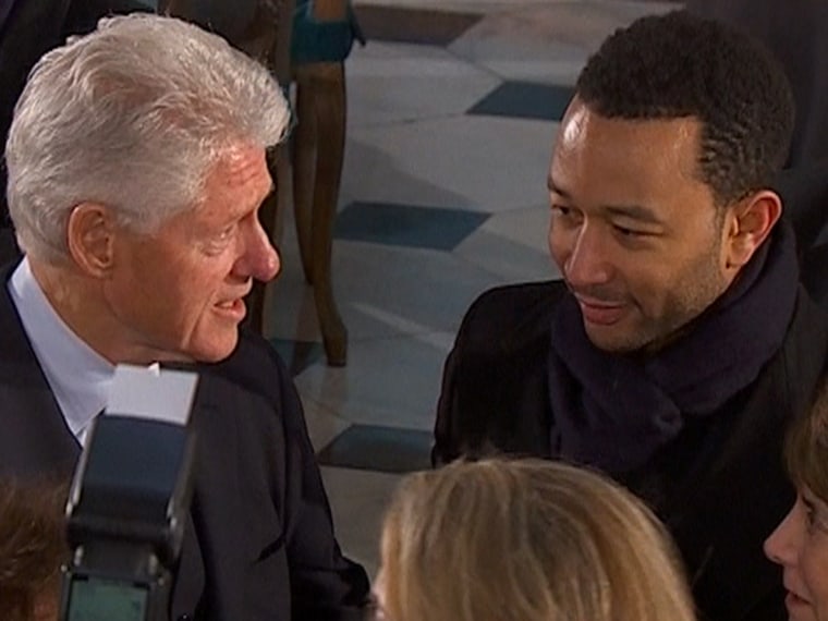Former President Bill Clinton chats with R&B singer John Legend after the presidential inauguration in Statuary Hall.