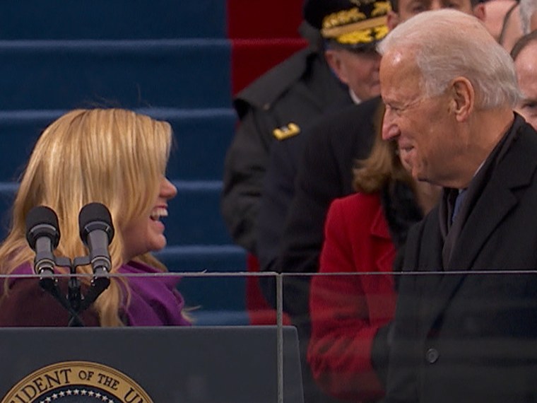 Singer Kelly Clarkson speaks with Vice President Joe Biden before her performance during the presidential inauguration.
