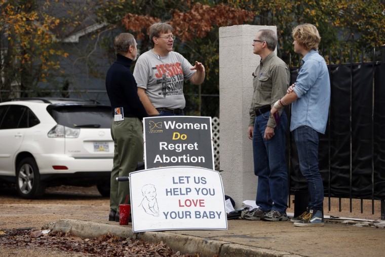 Abortion foe Cal Zastrow, second from left, stands outside Jackson Women's Health Organization Inc., Mississippi's only abortion clinic, with other protesters on January 11.