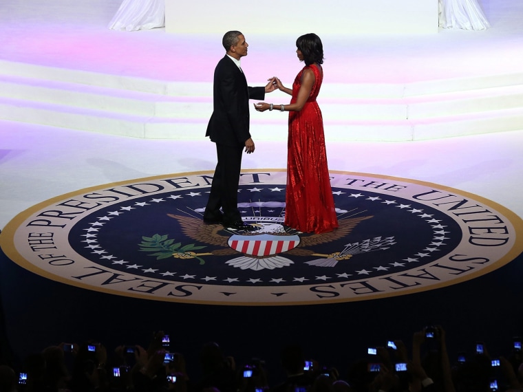 President Barack Obama and first lady Michelle Obama dance on the presidential seal at the Commander-in-Chief's Ball Monday night.