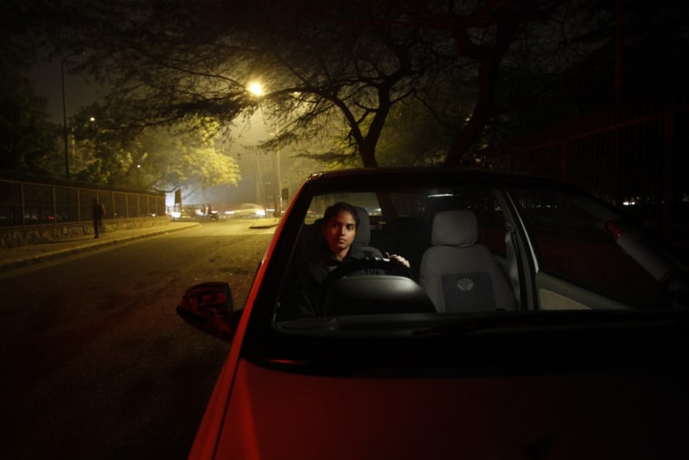 Chandani sits inside her car on a street in New Delhi.