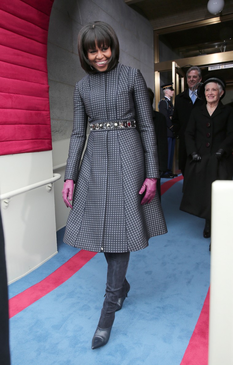 First lady Michelle Obama arrives at the presidential inauguration at the Capitol building wearing J Crew gloves, shoes and a sash as a belt.