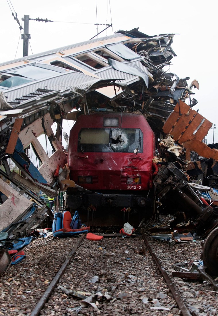 A train sits beneath the carriage of another train after they collided at a station in Alfarelos, Portugal, on Jan. 22.