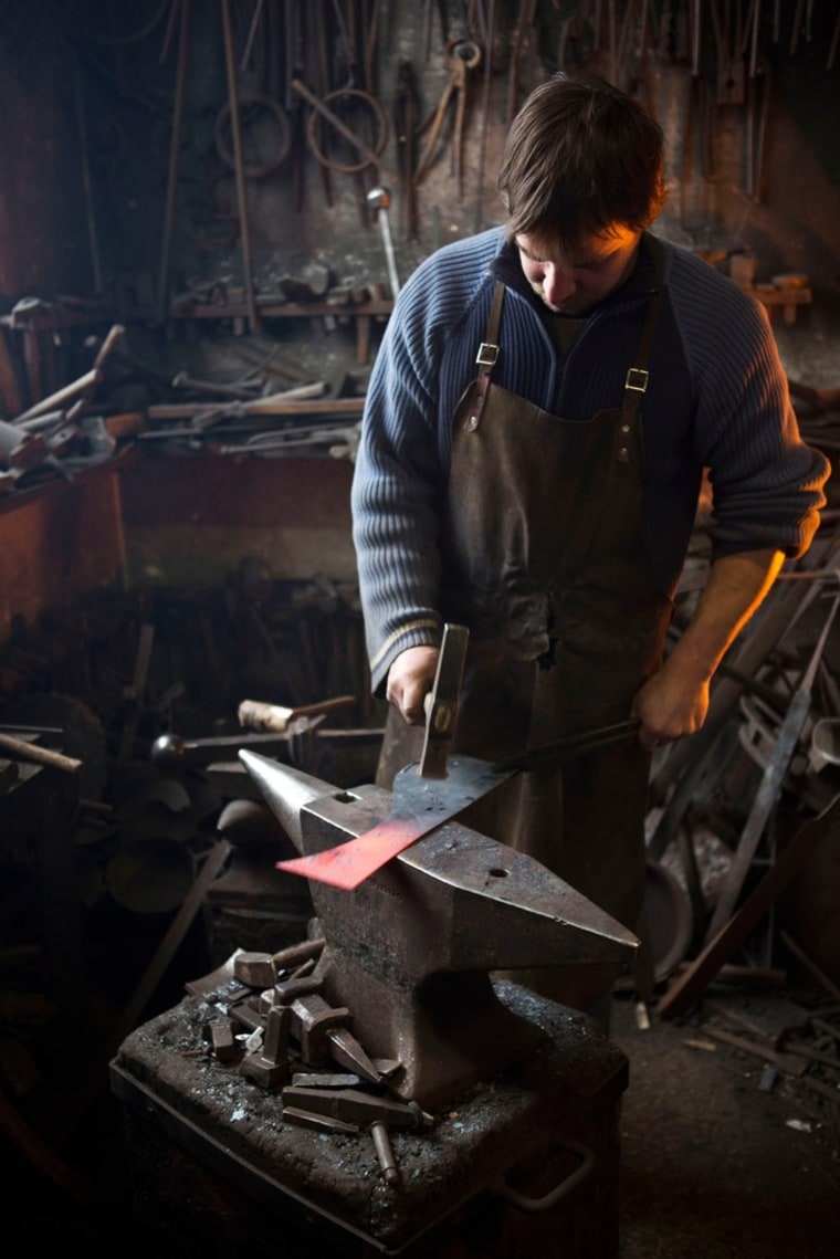 Blacksmith Georg Schmidberger crafts a piece of metal that will become part of a suit of armor.