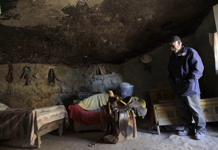 Benito Hernandez stands inside his family's bedroom at his home.