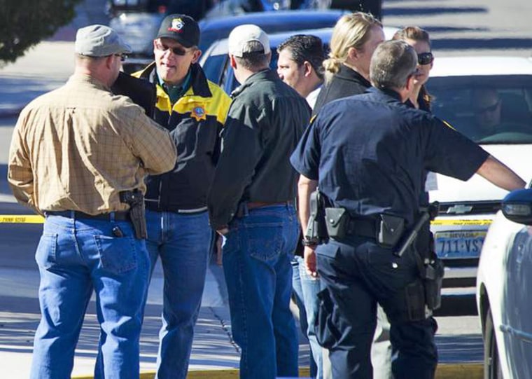 Law enforcement officials confer during a shooting investigation in Boulder City, Jan. 21, 2013.