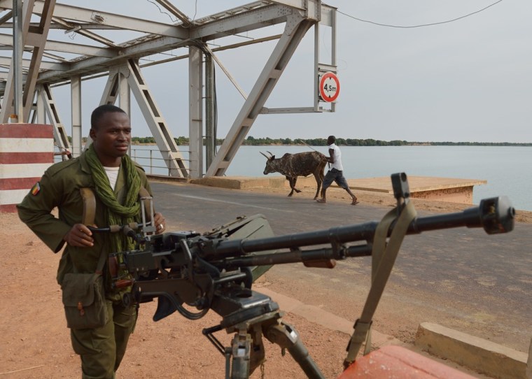 A Malian soldier holds a machine gun as he stands guard at the entrance of a strategic bridge over the Niger river on Jan. 22, 2013, near Markala, north of Bamako. Mali's army chief today said his French-backed forces could reclaim the northern towns of Gao and fabled Timbuktu from Islamists in a month, as the United States began airlifting French troops to Mali.