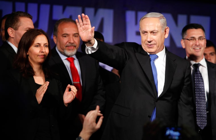 Israeli Prime Minister Benjamin Netanyahu waves to supporters at his election campaign headquarters early Wednesday morning in Tel Aviv. Exit polls indicate that Netanyahu was re-elected for a third term and will return to office. Israel had the highest turnout of voters since 1999.