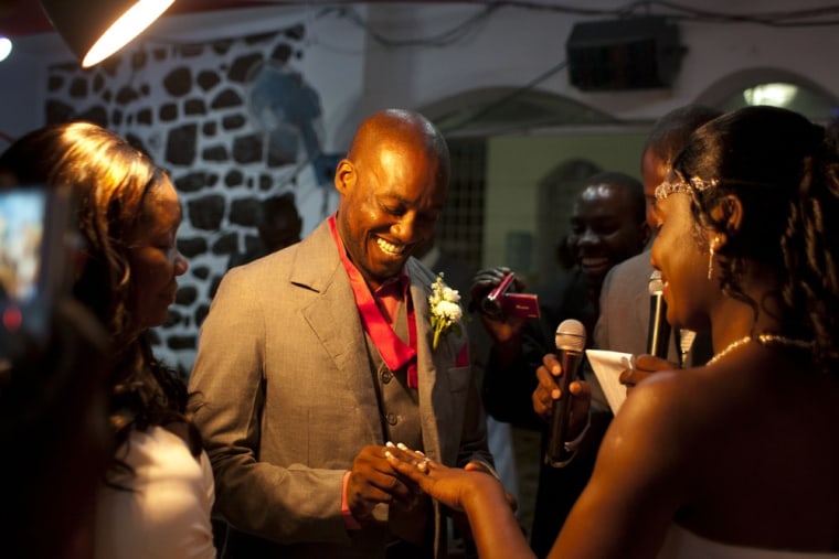 Exantus puts a ring on the finger of his bride Sherly Henrisme Exantus at their wedding in Port-au-Prince.